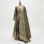 This stunning Anarkali suit comes in a beautiful olive green shade with golden embroidery that gives it a rich and classy look. The long, flowy kurta has a soft shine and delicate patterns all over adding a touch of grace and tradition.

The matching dupatta features fine floral embroidery and a detailed border that perfectly compliments the outfit.

Simple yet sophisticated, this set is ideal for festive gatherings, weddings or formal events where you want to look graceful and timeless.