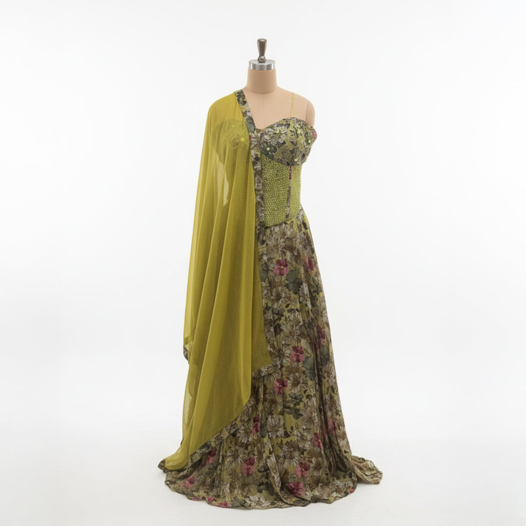 This is a beautiful floral lehenga with a corset-style blouse. The blouse has a mix of prints and light embroidery, giving it a stylish and modern look.

The skirt has a lovely floral pattern in soft green and pink tones that flow nicely. The matching light green dupatta adds a fresh and elegant touch.

Perfect for weddings, sangeet or festive events, this outfit is trendy, graceful and full of charm.