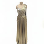 This glamorous outfit is in a rich metallic gold color. The balouse is covered in big, shiny mirror work that catches the light beautifully. It features a pre-draped saree style with neat pleats on the shoulder, making it very easy to wear without any hassle. The fabric is smooth and shiny. This outfit is bold, stylish, and perfect for cocktail parties and evening receptions.