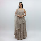 Radiate ethereal beauty in this Champagne Beige Net Sharara Set, featuring delicate 3D floral and tonal sequin embroidery. The soft, neutral palette and vine-like floral patterns create a dreamy, aesthetic that is perfect for an engagement or Nikah. Lightweight yet heavily detailed, this set offers a fairy-tale glow for your most special occasions.