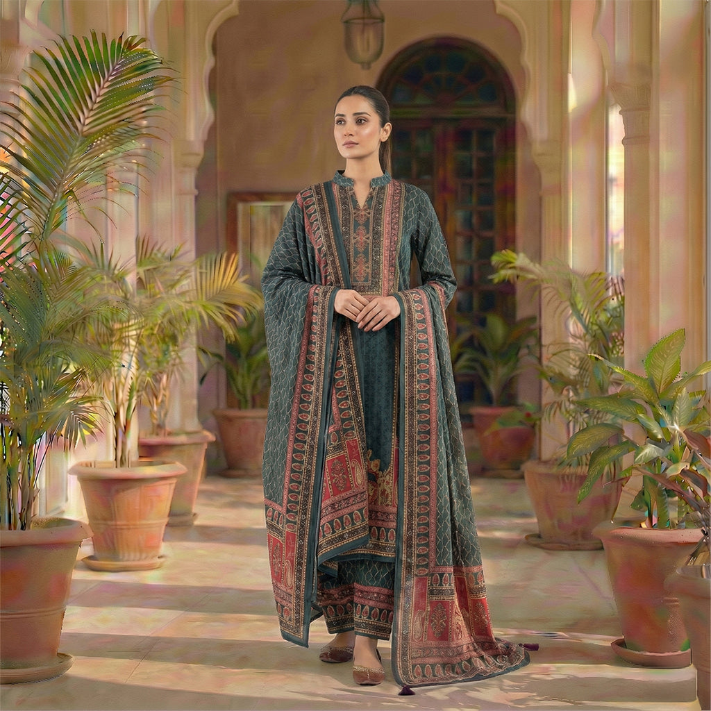 This traditional outfit is in a smart dark grey color. The kurta features a unique wavy line pattern all over and a detailed design on the neck in red and beige colors. It comes with matching pants and a beautiful shawl (dupatta) that has a rich, printed border. This outfit is elegant, comfortable, and perfect for office wear or casual winter days.