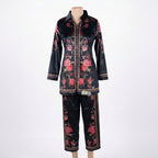 This trendy outfit is in a deep blue color. It features a shirt-style top with a smart collar and buttons down the front. It is decorated with beautiful pink floral patterns and has a stylish geometric border design. It comes with comfortable matching pants that have the same print. This outfit is chic, modern, and perfect for casual outings or smart daily wear.