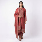 This elegant outfit is in a beautiful deep maroon color. The kurta features a swirling pattern all over and a special detailed design around the neck. It comes with matching pants and a warm shawl (dupatta) that completes the look. This outfit is cozy, traditional, and perfect for winter days and family gatherings.