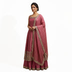 This charming outfit features a deep pink kurta with golden embroidery and small patterned details that give it a traditional yet stylish look. The neckline and borders are beautifully decorated with fine handwork, adding a touch of shine.

The flared bottom palazzo&nbsp; and the striped dupatta with a golden border completes the outfit perfectly.


Light, elegant and festive, this look is ideal for weddings, family gatherings or cultural celebrations where you want to appear graceful and radiant.