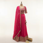 This is a bright pink outfit featuring a heavily embroidered blouse paired with flared palazzo. The blouse has intricate golden embroidery, giving it a festive and rich look.


The matching dupatta has small embroidery and a detailed border that adds elegance.&nbsp;This outfit is perfect for weddings, mehndi or festive events. It’s modern, stylish and full of charm.