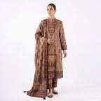 This elegant outfit is in a warm beige color. The long kurta features a collar neck with beautiful shiny beadwork on the chest. The fabric has a lovely floral print with red and green details. It comes with comfortable matching pants and a stylish shawl (dupatta) that has a dark, patterned border. This outfit is classy, traditional, and perfect for casual gatherings and winter days.