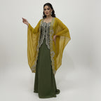 This is an outfit with a stylish twist. It features an dark-green top paired with matching palazzo and a mustard-yellow cape.
The top has beautiful silver embroidery on the front, adding a rich and classy touch. The flowy cape, decorated with heavy embroidery along the edges, gives the outfit a modern and graceful look.
Perfect for formal occasions or festive events, this outfit blends traditional style with a contemporary flair, perfect for parties, wedding and festive look.