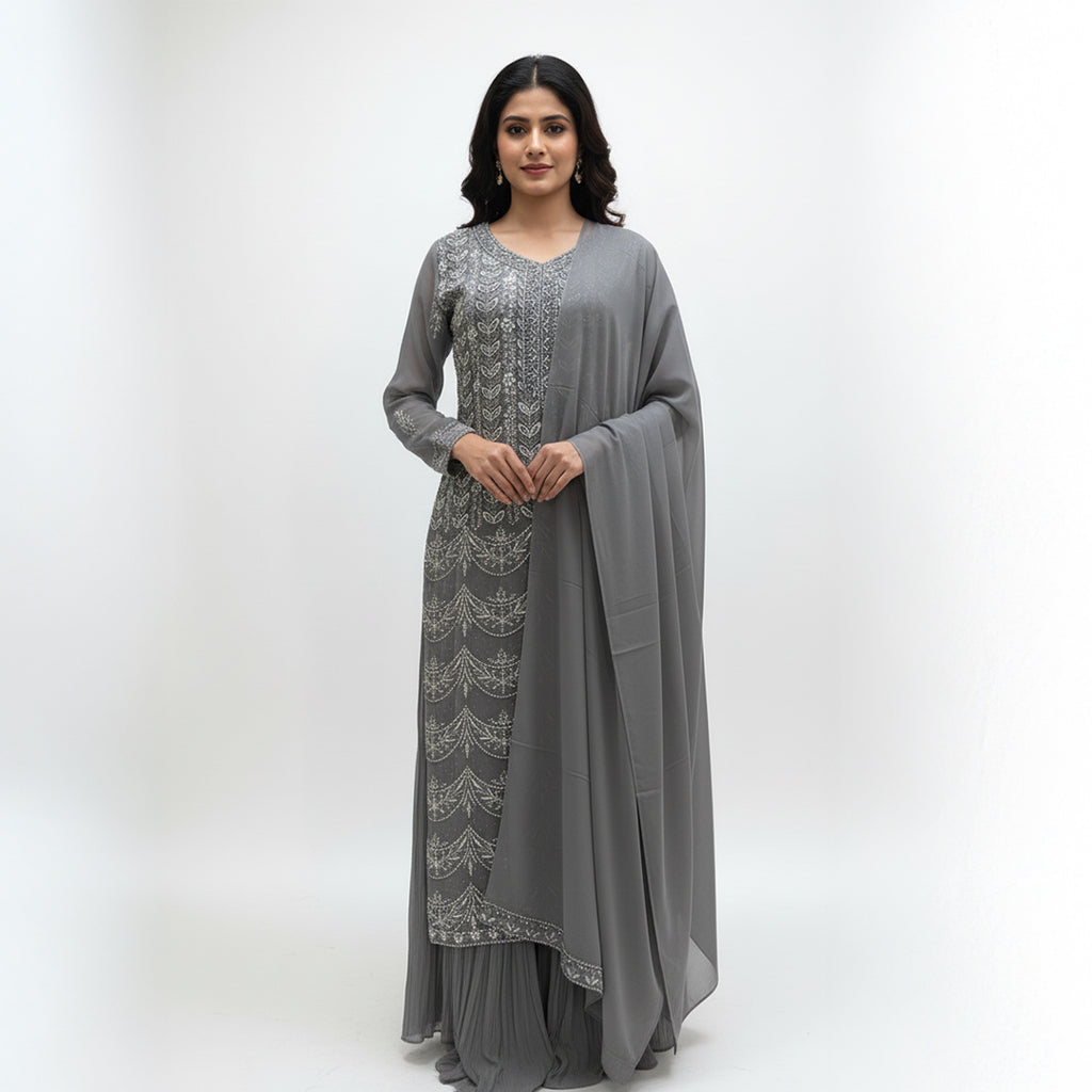 This outfit is in a lovely grey color with pretty silver embroidery all over the front and sleeves. The work is neat and shiny, making it look graceful and stylish.

It has a long, flowy design that looks elegant and is easy to wear. The matching dupatta adds a soft and simple touch to the outfit.

Perfect for parties or special events, this dress is classy, beautiful, and simple.