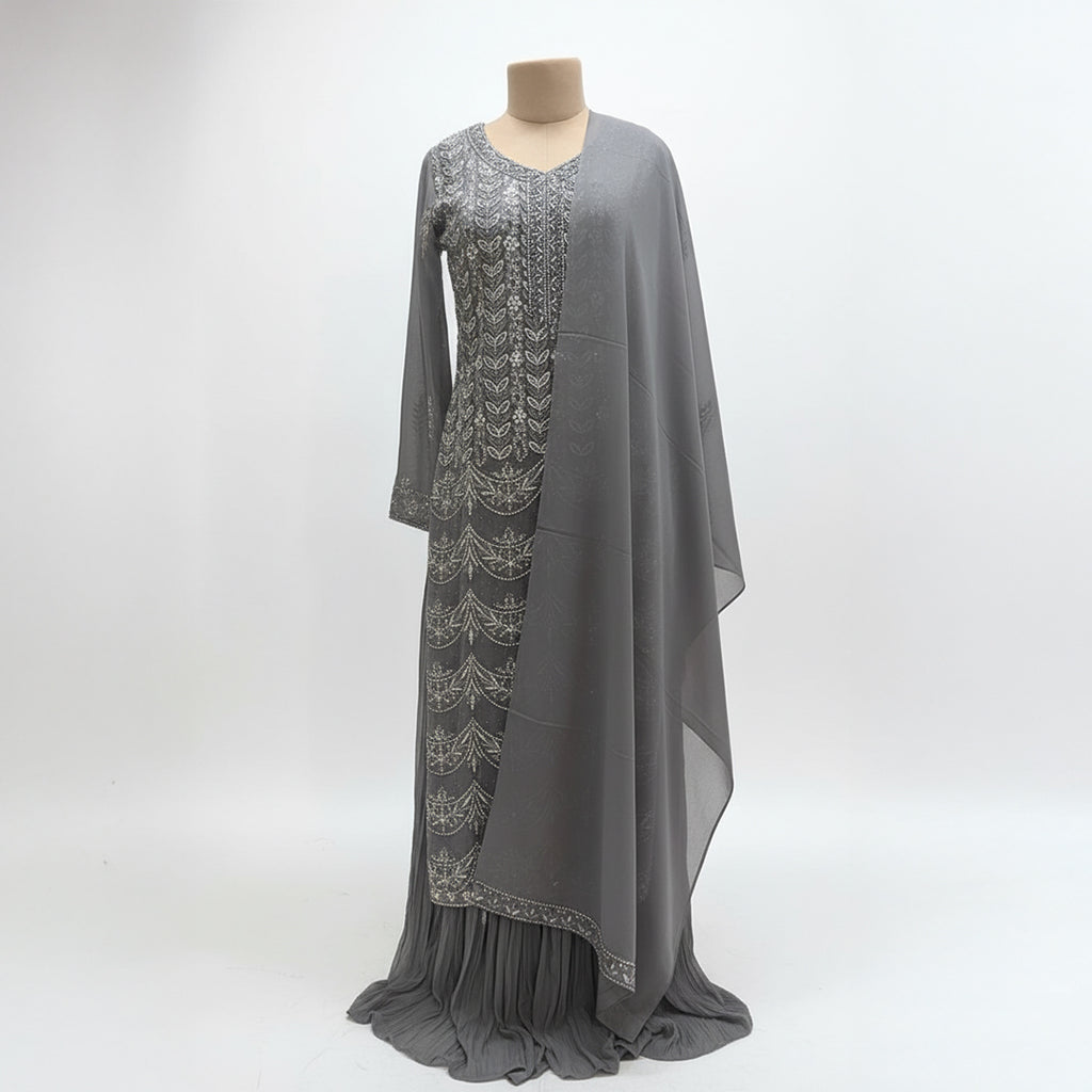 This outfit is in a lovely grey color with pretty silver embroidery all over the front and sleeves. The work is neat and shiny, making it look graceful and stylish.

It has a long, flowy design that looks elegant and is easy to wear. The matching dupatta adds a soft and simple touch to the outfit.

Perfect for parties or special events, this dress is classy, beautiful, and simple.