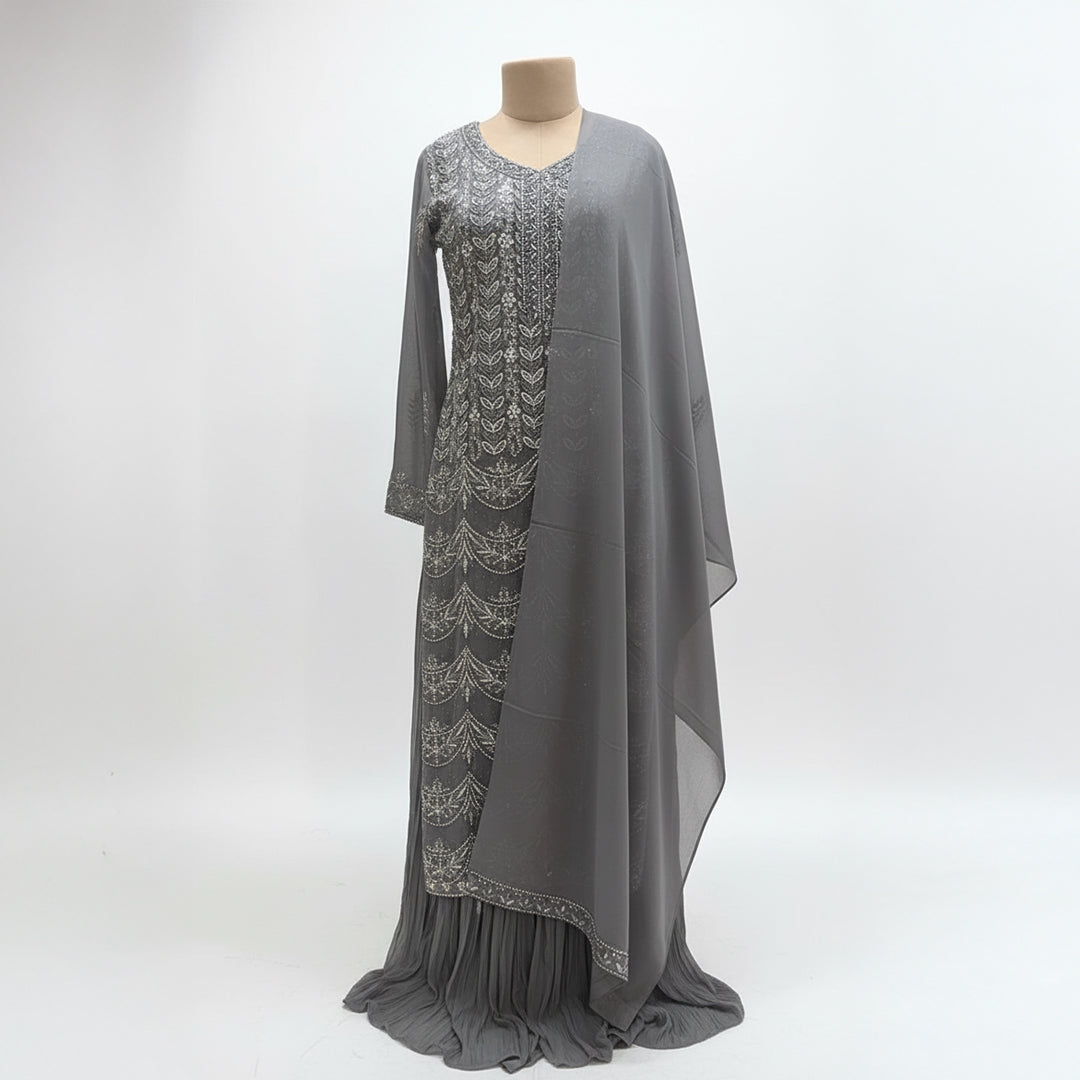 This outfit is in a lovely grey color with pretty silver embroidery all over the front and sleeves. The work is neat and shiny, making it look graceful and stylish.

It has a long, flowy design that looks elegant and is easy to wear. The matching dupatta adds a soft and simple touch to the outfit.

Perfect for parties or special events, this dress is classy, beautiful, and simple.