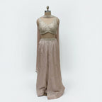 This stunning ivory embellished crop top and matching wide-leg palazzo pants set. This chic fusion wear ensemble perfectly balances modern style with traditional elegance.

The beautifully detailed crop top features intricate, shimmering embellishments, while the flowing, wide-leg pants provide a flattering and comfortable fit.

It’s the perfect choice for making a statement at any wedding function, from a lively sangeet night to an elegant engagement party, or for any festive event where you want to shine.