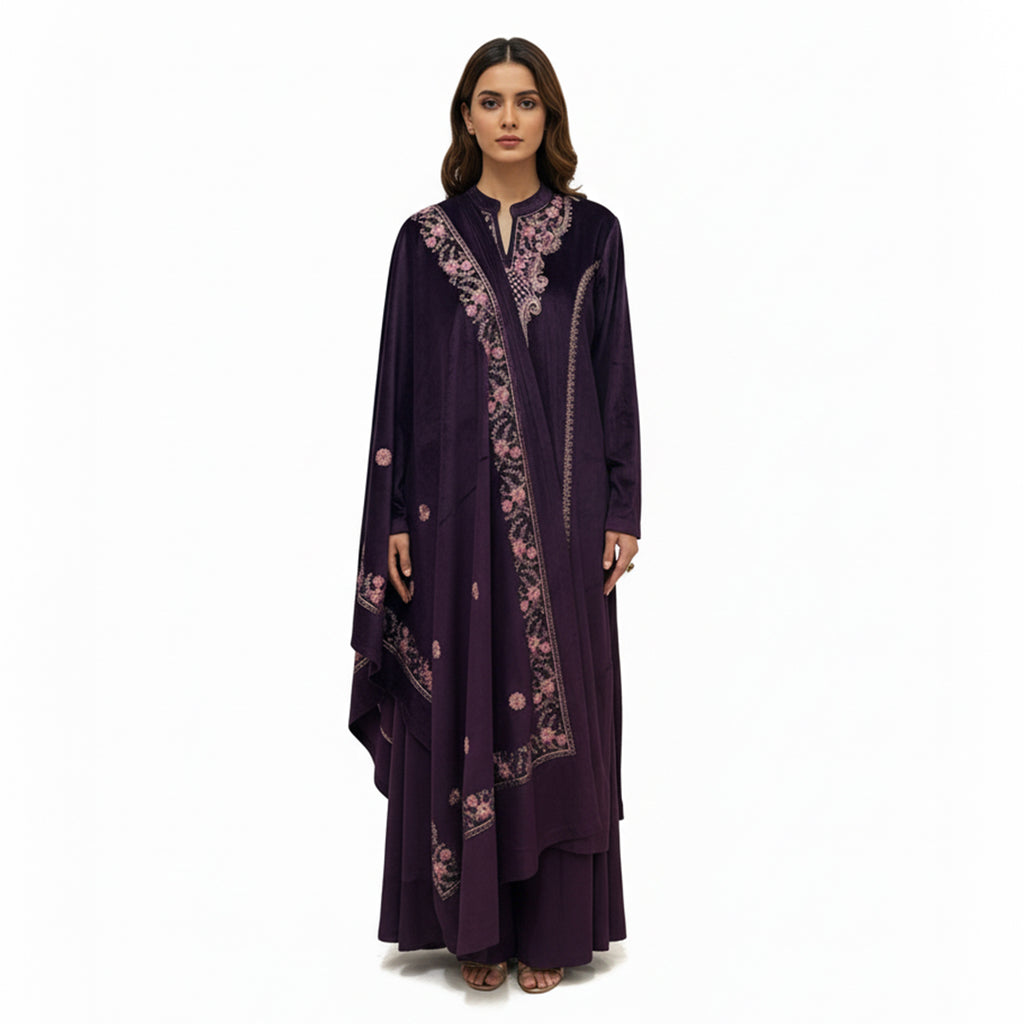 This cozy and stylish outfit is perfect for winter. It is made from soft velvet fabric in a beautiful deep purple color.

The kurta features pretty pink floral embroidery around the neck and shoulders.

It comes with comfortable matching pants and a warm velvet shawl (dupatta) that completes the look. This outfit is elegant, warm, and great for winter parties and family gatherings.