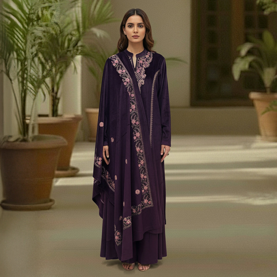 This cozy and stylish outfit is perfect for winter. It is made from soft velvet fabric in a beautiful deep purple color.

The kurta features pretty pink floral embroidery around the neck and shoulders.

It comes with comfortable matching pants and a warm velvet shawl (dupatta) that completes the look. This outfit is elegant, warm, and great for winter parties and family gatherings.