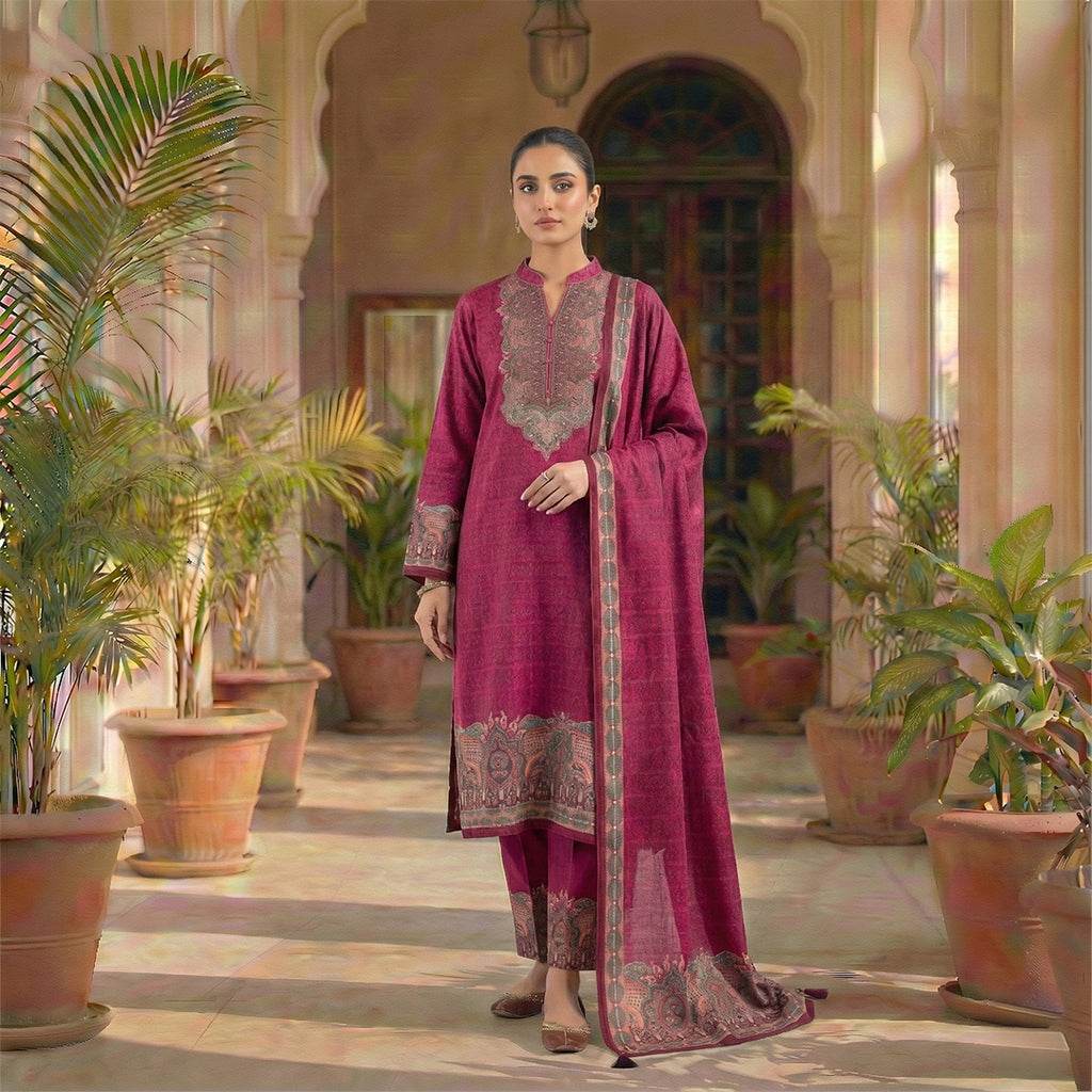 This stylish outfit is in a beautiful deep pink color. The long kurta has a nice pattern all over and a detailed traditional design around the neck. It features long sleeves and a lovely border at the bottom. It comes with matching pants and a warm shawl (dupatta) that has a pretty printed border. This outfit is cozy, elegant, and perfect for winter gatherings and daily wear.
