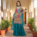This vibrant outfit is in a rich teal color. The kurta has beautiful multicolored embroidery with detailed patterns and mirror work, giving it a festive look. It comes with a flowy, pleated palazoo and a matching dupatta.

This outfit is bright, elegant, and perfect for weddings, mehndi functions, and festive celebrations.