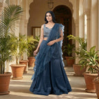 This glamorous outfit is in a beautiful deep blue color. The sleeveless top is covered in shiny silver beads and pearls, giving it a sparkling look.

It comes with smooth, flowy palazzo pants made of soft fabric.&nbsp;The look is completed with a matching sheer dupatta that has stylish frills on the edges. This outfit is chic, eye-catching, and perfect for sangeet nights, parties, and festive events.