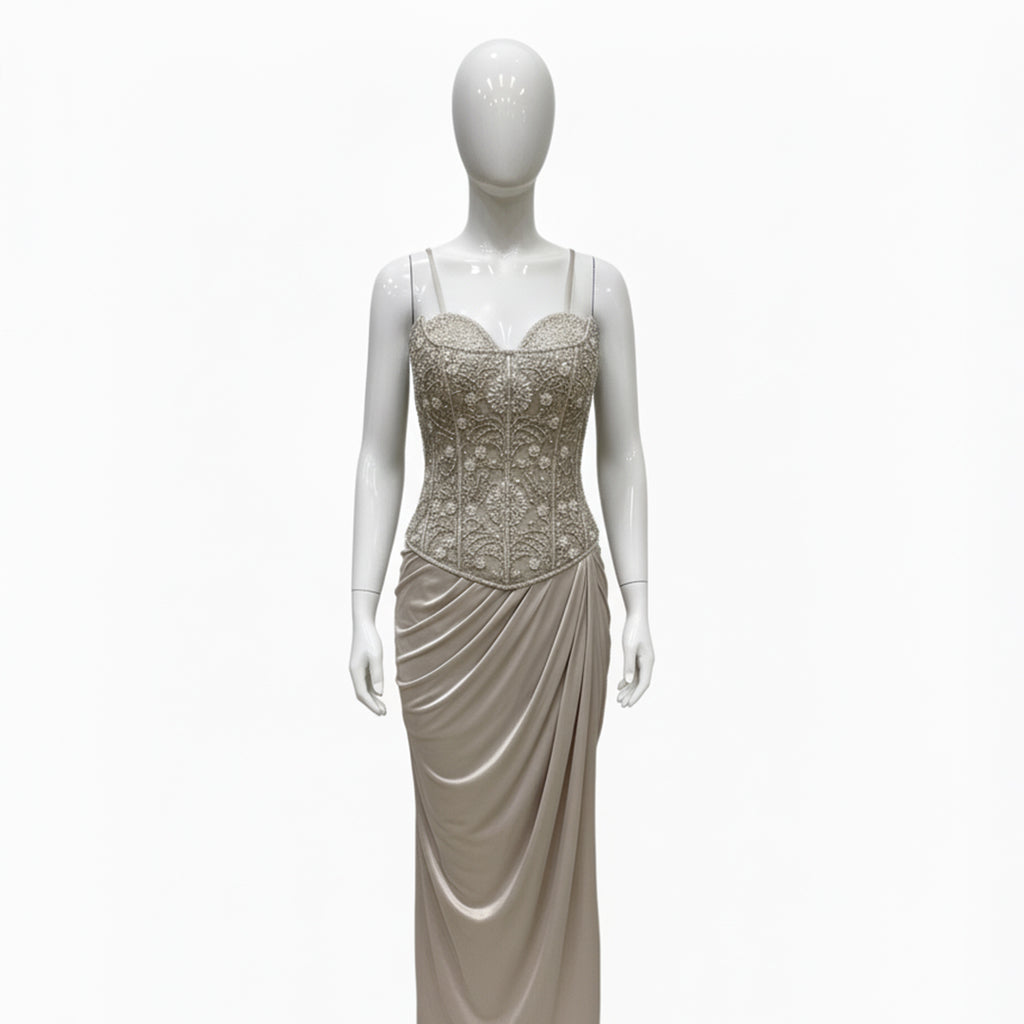 This is an elegant two-piece white color Indo-Western ensemble.

The outfit features a structured, intricately embroidered corset-style bustier top paired with a long, gracefully draped skirt.

This contemporary and chic set is suitable for formal events, cocktail parties, and festive occasions