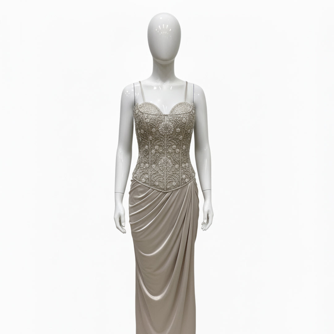 This is an elegant two-piece white color Indo-Western ensemble.

The outfit features a structured, intricately embroidered corset-style bustier top paired with a long, gracefully draped skirt.

This contemporary and chic set is suitable for formal events, cocktail parties, and festive occasions