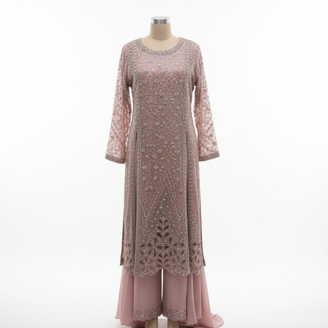 This elegant outfit is designed in a soft blush pink shade with delicate silver embroidery all over, giving it a graceful and classy look. The long kurta features detailed handwork with floral and geometric patterns that add a touch of sophistication.

The matching palazzo pants have a simple yet elegant border that complements the overall design beautifully.&nbsp;Perfect for weddings, receptions or festive occasions, this outfit combines subtle shine with timeless charm, making it ideal for an elegant and 