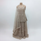 Radiate ethereal beauty in this Champagne Beige Net Sharara Set, featuring delicate 3D floral and tonal sequin embroidery. The soft, neutral palette and vine-like floral patterns create a dreamy, aesthetic that is perfect for an engagement or Nikah. Lightweight yet heavily detailed, this set offers a fairy-tale glow for your most special occasions.