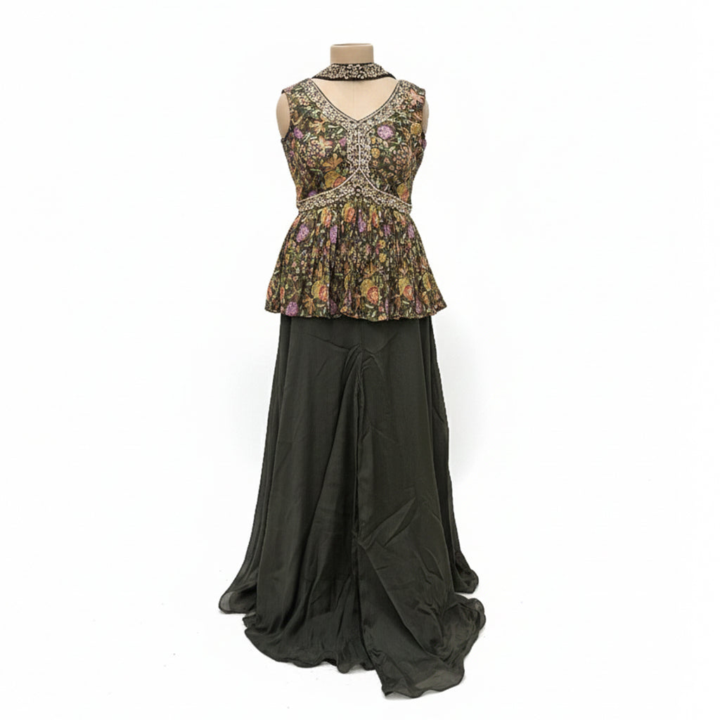This stylish outfit features a short frock-style top with a beautiful floral print and detailed embroidery on the V-neckline. It is paired with a solid, dark-colored palazzo that is smooth and flowy. The set includes a matching dupatta, making it a trendy and elegant choice for parties.