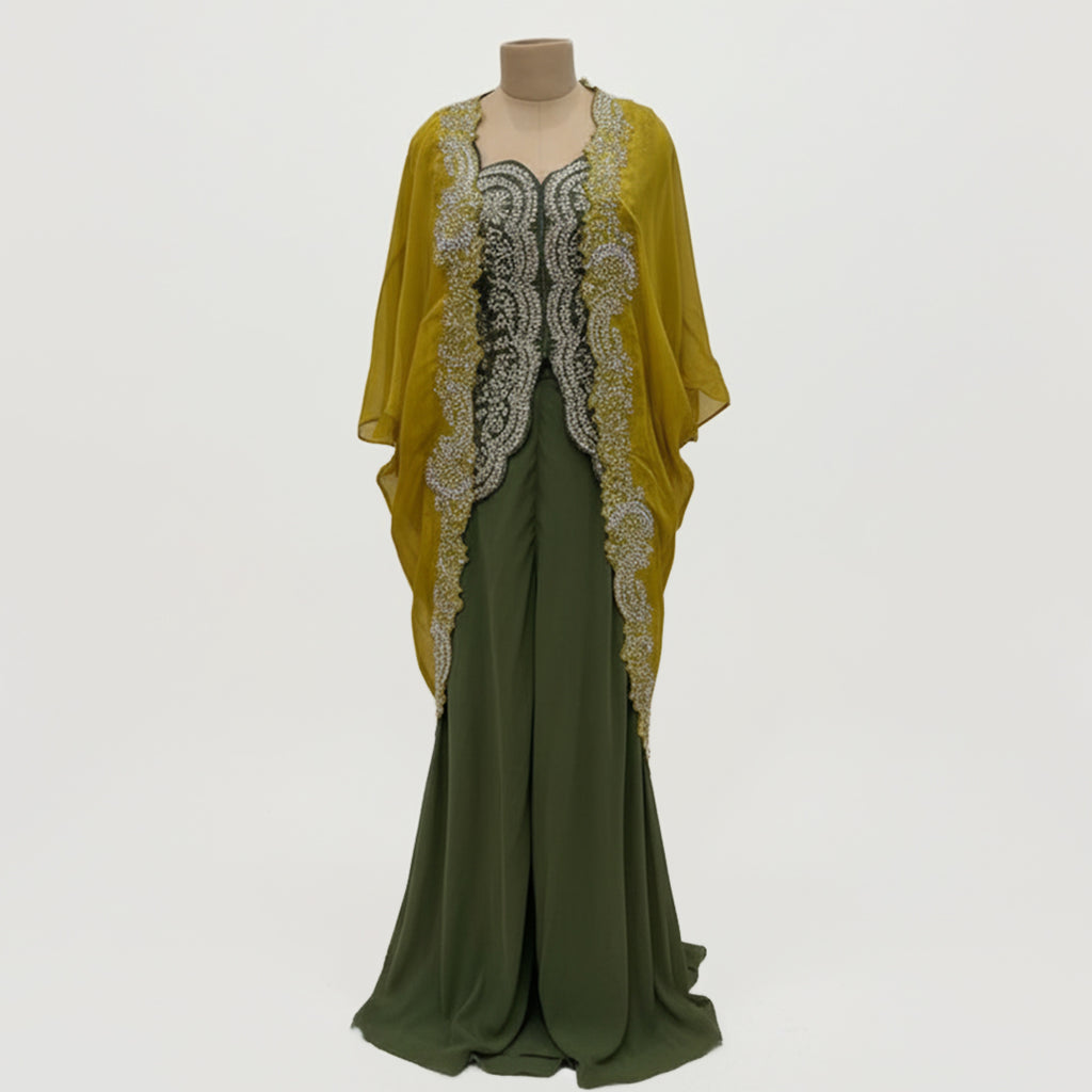 This is an outfit with a stylish twist. It features an dark-green top paired with matching palazzo and a mustard-yellow cape.
The top has beautiful silver embroidery on the front, adding a rich and classy touch. The flowy cape, decorated with heavy embroidery along the edges, gives the outfit a modern and graceful look.
Perfect for formal occasions or festive events, this outfit blends traditional style with a contemporary flair, perfect for parties, wedding and festive look.
