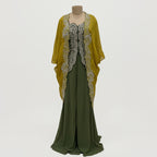This is an outfit with a stylish twist. It features an dark-green top paired with matching palazzo and a mustard-yellow cape.
The top has beautiful silver embroidery on the front, adding a rich and classy touch. The flowy cape, decorated with heavy embroidery along the edges, gives the outfit a modern and graceful look.
Perfect for formal occasions or festive events, this outfit blends traditional style with a contemporary flair, perfect for parties, wedding and festive look.