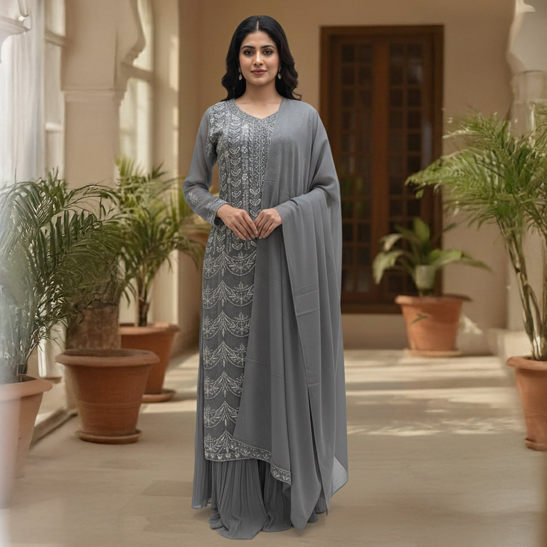 This outfit is in a lovely grey color with pretty silver embroidery all over the front and sleeves. The work is neat and shiny, making it look graceful and stylish.

It has a long, flowy design that looks elegant and is easy to wear. The matching dupatta adds a soft and simple touch to the outfit.

Perfect for parties or special events, this dress is classy, beautiful, and simple.