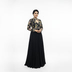 This elegant, full-length black gown features a high-neck bodice adorned with intricate, multi-colored floral embroidery.

The dress has long sleeves and a defined waistline, flowing into a voluminous, pleated skirt that reaches the floor.

The style blends traditional motifs with a modern look, making it a sophisticated choice for formal events or evening wear.