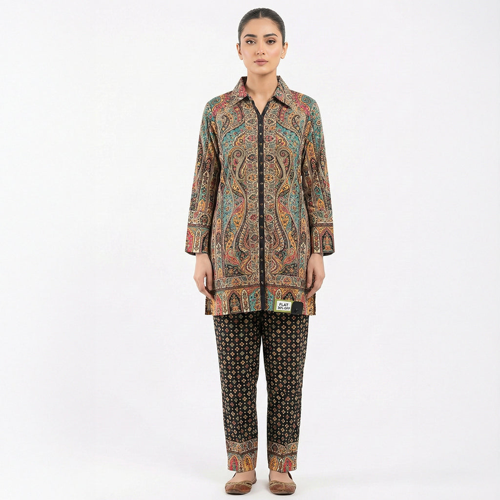 This trendy outfit is full of colors. The top is a shirt-style kurta with a smart collar and buttons down the front. It features a rich, detailed print with teal, beige, and red patterns. It comes with contrasting black pants that have a cute, small geometric design. This outfit is smart, unique, and perfect for casual wear or office days.