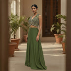 This contemporary ethnic outfit features a sleeveless V-neck crop top shimmering with intricate hand-embroidery, sequins, and beadwork.

It is perfectly paired with floor-length, wide-legged trousers in a coordinating shade of olive green.

The pants are designed with an elegant, draped silhouette, crafted from a lightweight, flowy material that moves beautifully. Perfect for parties, weddings, festive looks