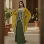 This is an outfit with a stylish twist. It features an dark-green top paired with matching palazzo and a mustard-yellow cape.
The top has beautiful silver embroidery on the front, adding a rich and classy touch. The flowy cape, decorated with heavy embroidery along the edges, gives the outfit a modern and graceful look.
Perfect for formal occasions or festive events, this outfit blends traditional style with a contemporary flair, perfect for parties, wedding and festive look.
