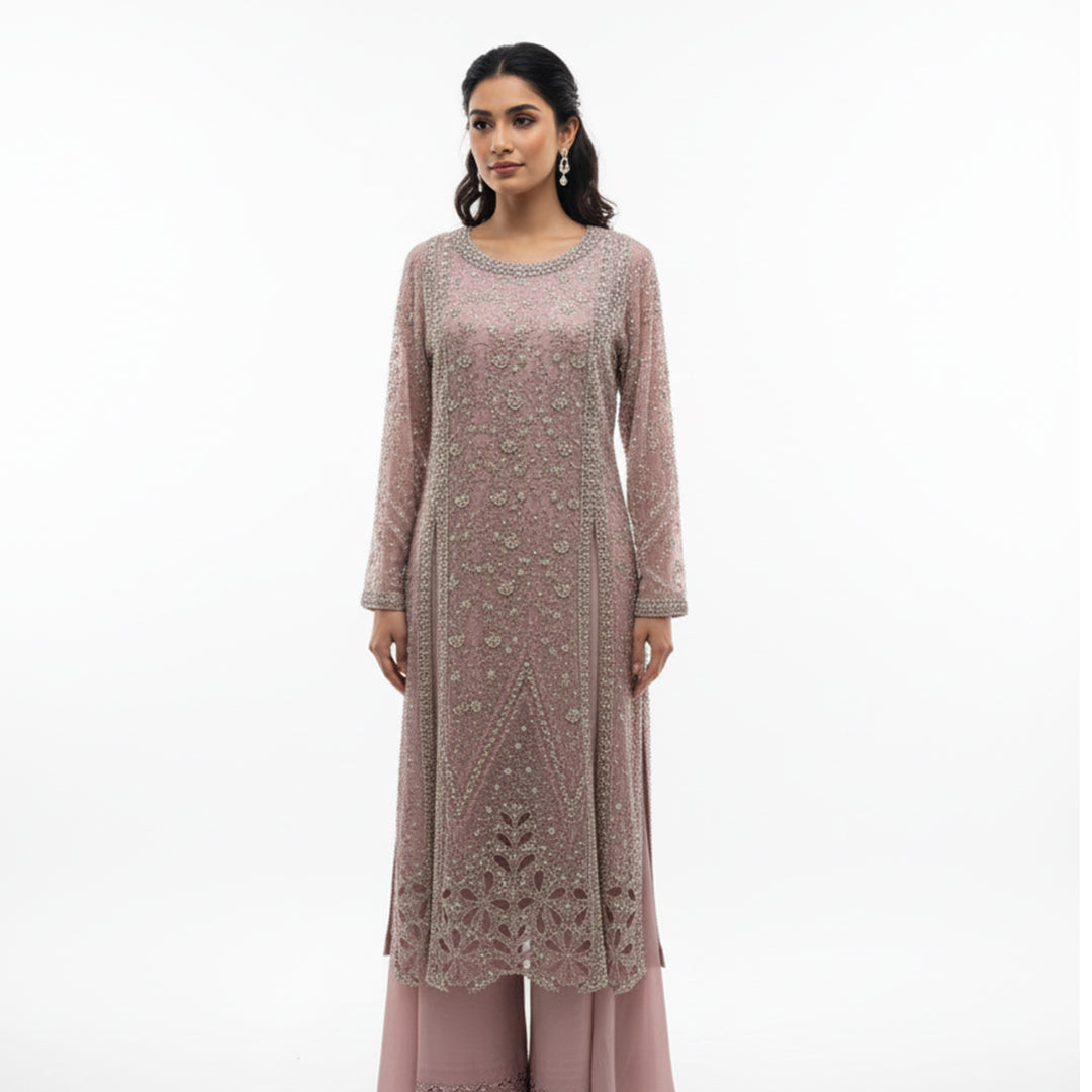 This elegant outfit is designed in a soft blush pink shade with delicate silver embroidery all over, giving it a graceful and classy look. The long kurta features detailed handwork with floral and geometric patterns that add a touch of sophistication.

The matching palazzo pants have a simple yet elegant border that complements the overall design beautifully.&nbsp;Perfect for weddings, receptions or festive occasions, this outfit combines subtle shine with timeless charm, making it ideal for an elegant and 