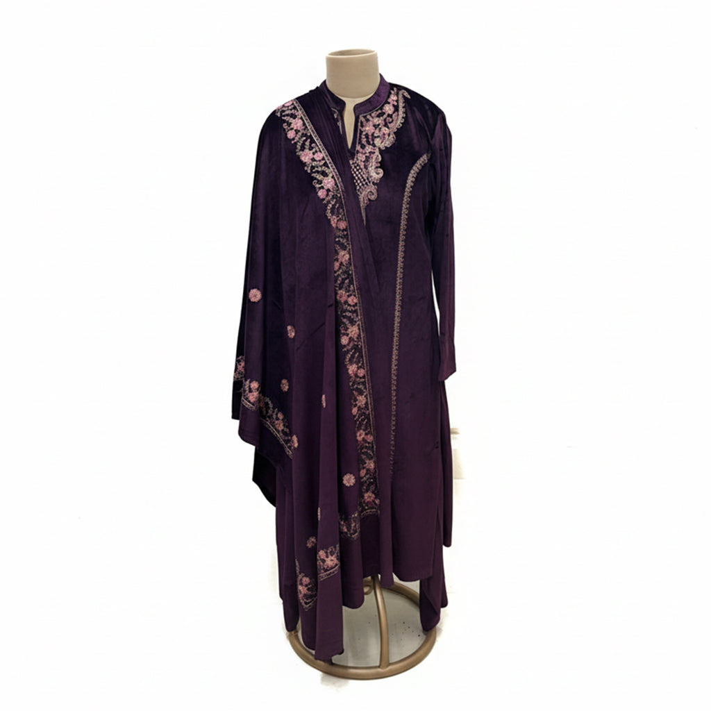 This cozy and stylish outfit is perfect for winter. It is made from soft velvet fabric in a beautiful deep purple color.

The kurta features pretty pink floral embroidery around the neck and shoulders.

It comes with comfortable matching pants and a warm velvet shawl (dupatta) that completes the look. This outfit is elegant, warm, and great for winter parties and family gatherings.