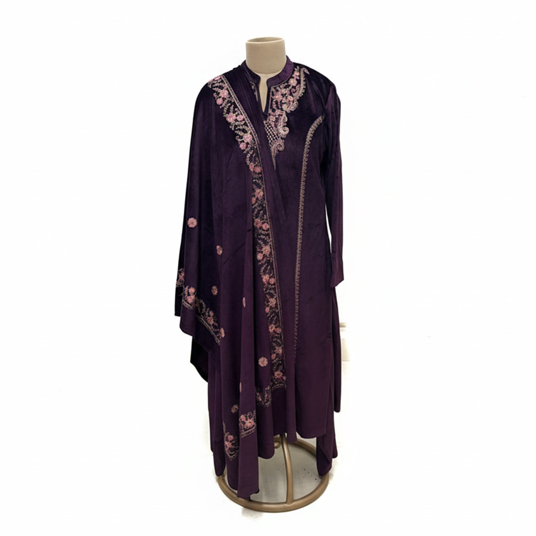 This cozy and stylish outfit is perfect for winter. It is made from soft velvet fabric in a beautiful deep purple color.

The kurta features pretty pink floral embroidery around the neck and shoulders.

It comes with comfortable matching pants and a warm velvet shawl (dupatta) that completes the look. This outfit is elegant, warm, and great for winter parties and family gatherings.