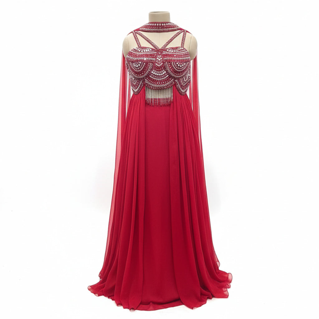 This dazzling outfit is in a beautiful red color. It features a stylish cut-out kurta that is heavily decorated with shiny silver beads and mirrors. It has a high-neck design and cute hanging tassels at the waist. It comes with flowy palazzo pants and a matching sheer dupatta. This outfit is bold, modern, and perfect for cocktail parties and evening events.