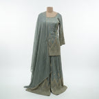 Green Georgette Sharara Set, featuring dazzling  sequin stripes that create a flattering, elongated silhouette. The heavily flared bottoms provide the volume of a lehenga with the comfort of a sharara. Finished with intricate scalloped borders and shimmering stonework, this ensemble is a high-impact choice for wedding receptions and evening galas.