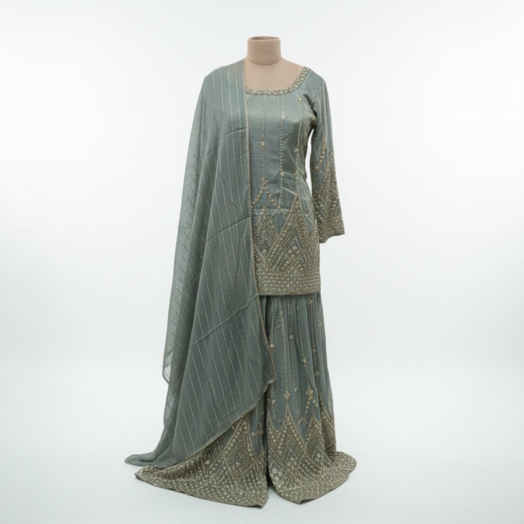 Green Georgette Sharara Set, featuring dazzling  sequin stripes that create a flattering, elongated silhouette. The heavily flared bottoms provide the volume of a lehenga with the comfort of a sharara. Finished with intricate scalloped borders and shimmering stonework, this ensemble is a high-impact choice for wedding receptions and evening galas.