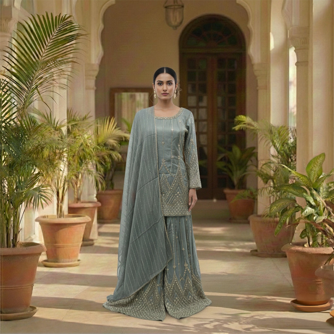 Step into the light with our Sage Green Georgette Sharara Set, featuring dazzling  sequin stripes that create a flattering, elongated silhouette. The heavily flared bottoms provide the volume of a lehenga with the comfort of a sharara. Finished with intricate scalloped borders and shimmering stonework, this ensemble is a high-impact choice for wedding receptions and evening galas.