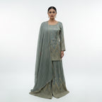 Green Georgette Sharara Set, featuring dazzling  sequin stripes that create a flattering, elongated silhouette. The heavily flared bottoms provide the volume of a lehenga with the comfort of a sharara. Finished with intricate scalloped borders and shimmering stonework, this ensemble is a high-impact choice for wedding receptions and evening galas.