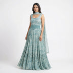 Embrace boho-luxe vibes with this Seafoam Green Georgette Maxi, featuring a bird and floral print. The tiered ruffle hem adds movement, while the hand-beaded turquoise waist belt and matching neckpiece provide a high-fashion edge. This lightweight, breathable gown is perfect for destination weddings, Mehendi parties, or any sun-drenched outdoor celebration