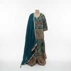 Celebrate vibrant heritage in this Teal Blue Silk Gharara Set, featuring traditional peacock color and rich thread work. The kurta’s multi-colored borders and intricate Zari details offer a stunning cultural aesthetic, while the flared gharara bottoms add a dramatic touch to your walk. It’s a bold, artistic masterpiece perfect for festive celebrations and Mehndi functions.