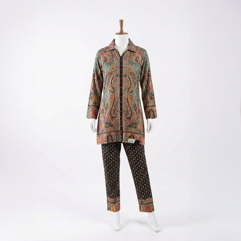 This trendy outfit is full of colors. The top is a shirt-style kurta with a smart collar and buttons down the front. It features a rich, detailed print with teal, beige, and red patterns. It comes with contrasting black pants that have a cute, small geometric design. This outfit is smart, unique, and perfect for casual wear or office days.