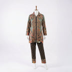This trendy outfit is full of colors. The top is a shirt-style kurta with a smart collar and buttons down the front. It features a rich, detailed print with teal, beige, and red patterns. It comes with contrasting black pants that have a cute, small geometric design. This outfit is smart, unique, and perfect for casual wear or office days.