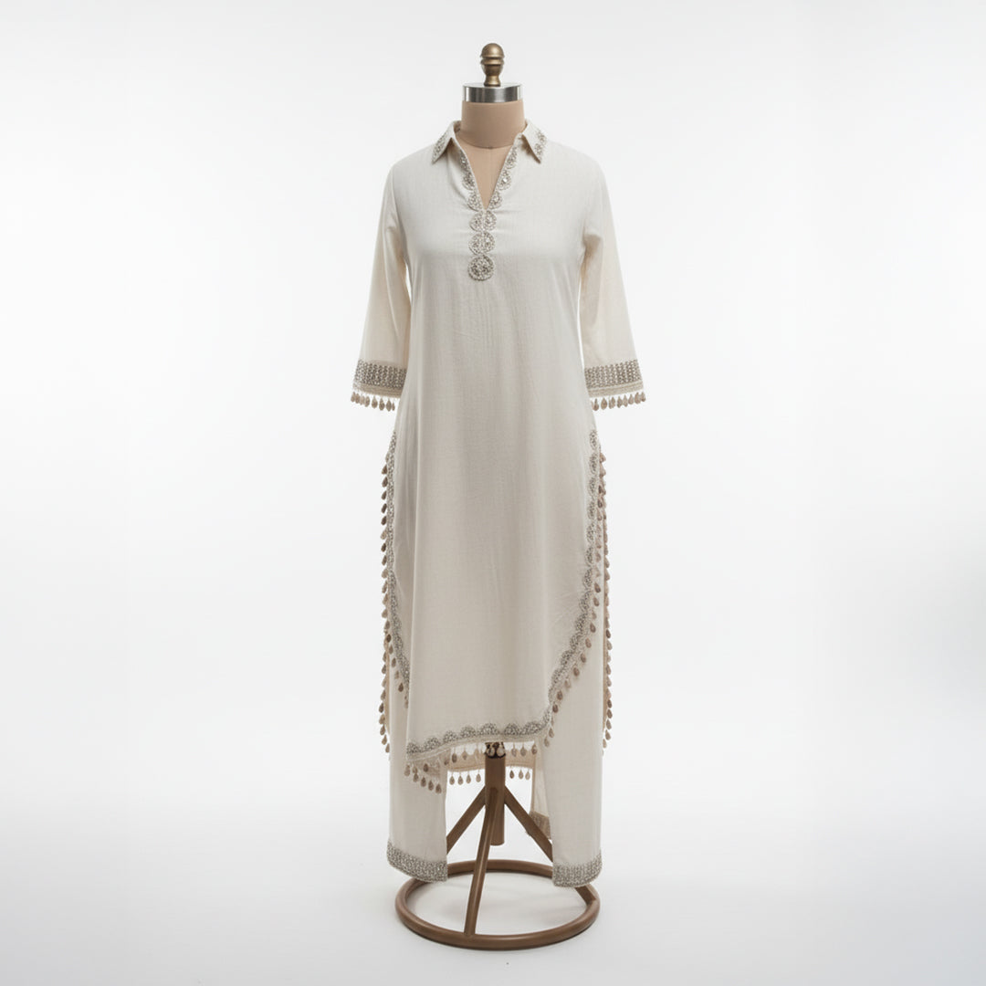 This simple and elegant outfit in a soft off-white color with delicate silver embroidery. The neckline, sleeves and borders are beautifully detailed with fine threadwork and tiny tassels that add a charming touch.

The straight cut and light fabric give it a graceful and comfortable look, perfect for both casual and semi-formal occasions.


Minimal yet classy, this outfit is ideal for daytime gatherings, festive lunches or when you want to look effortlessly stylish.